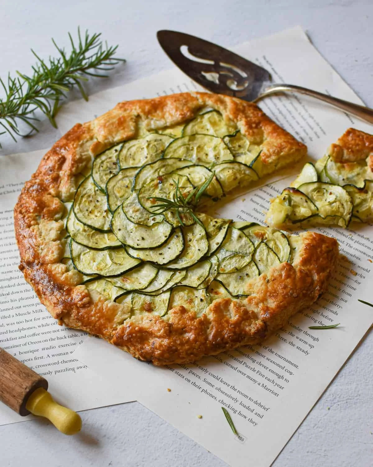 Zucchini Ricotta Galette served on a rustic plate with fresh herbs.