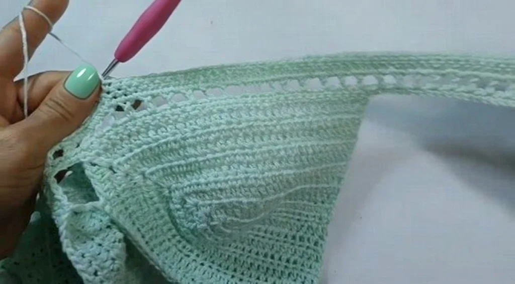 Tutorial image showing joined crochet halter top cups with chain neck strap attachment